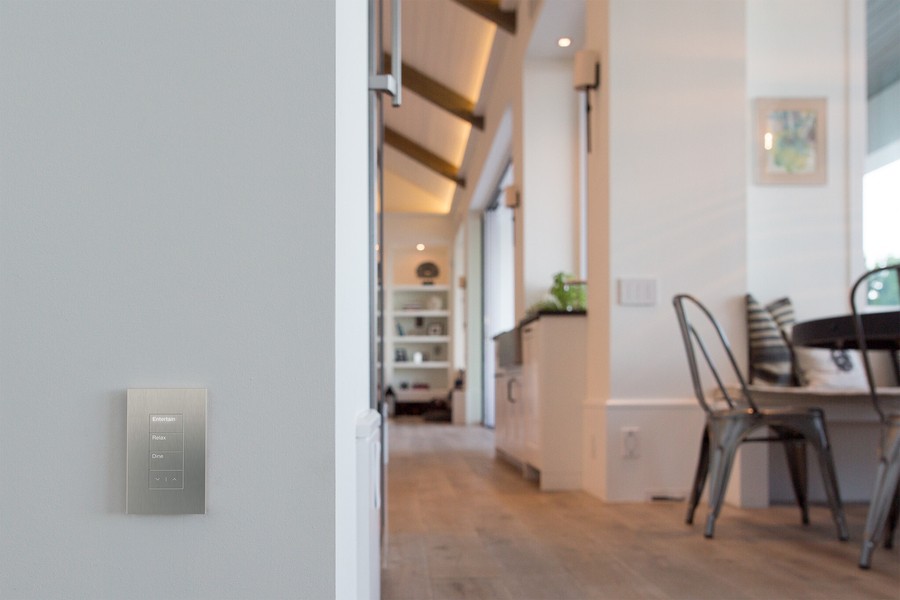 A home interior with an LED-lit Lutron lighting wall keypad.